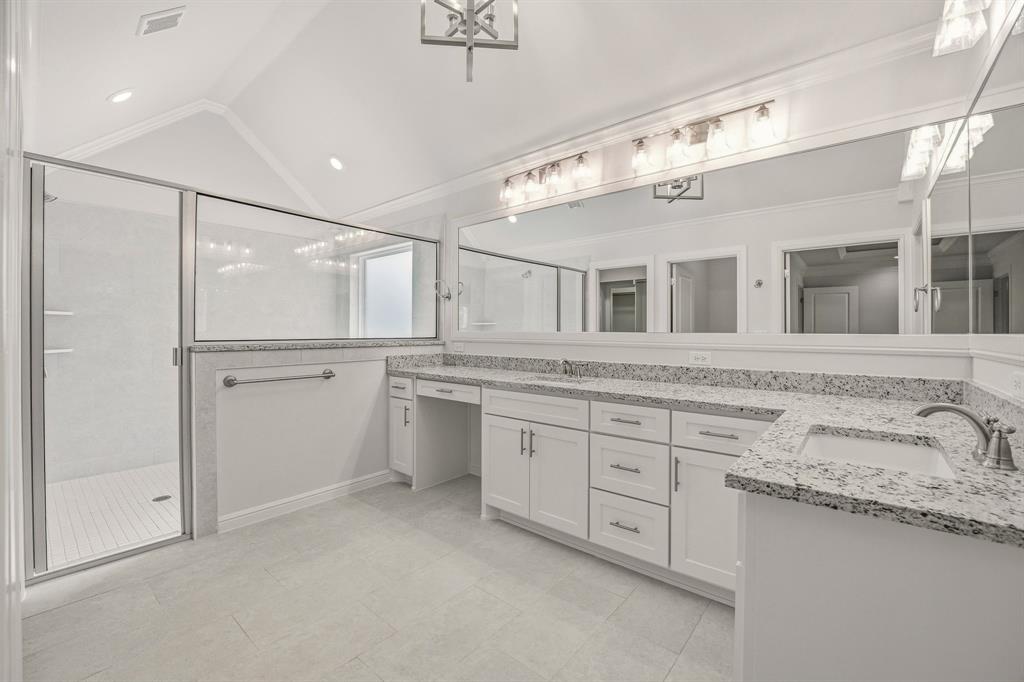 2017 Forest Bridge Azle, TX 76020 - Photo 17 of 30 Bathroom featuring double vanity, a shower stall, hanging lights, and vaulted ceiling