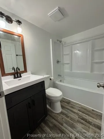 a bathroom with a toilet a sink a mirror and a bathtub