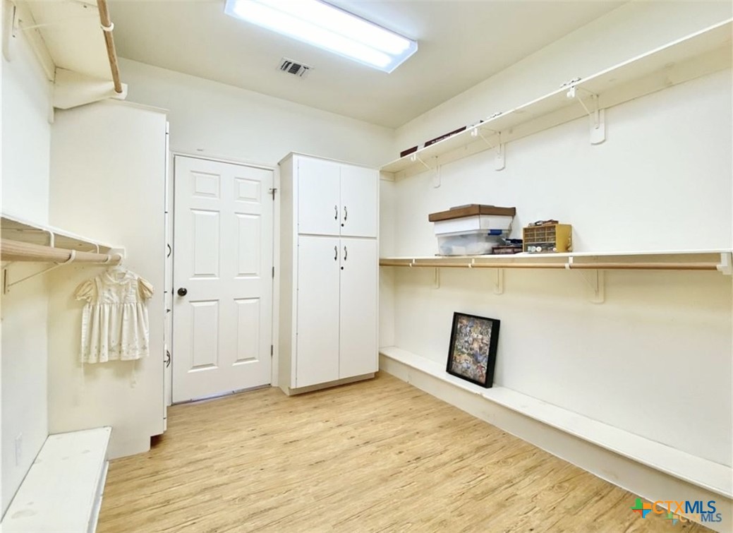 415 South Trinity Street Edna, TX 77957 - Photo 28 of 46 a view of a kitchen with a refrigerator and wooden floor