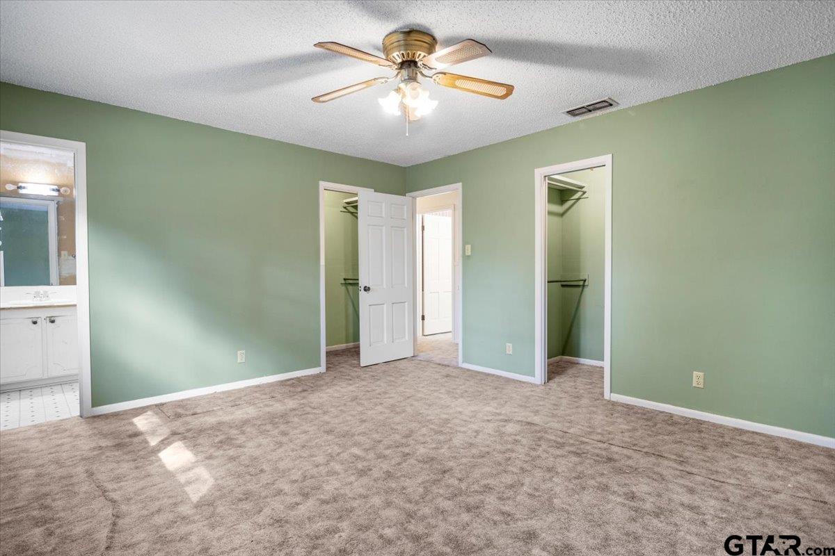 1302 Jeb Stuart Drive Tyler, TX 75703 - Photo 21 of 47 a view of a room with a chandelier fan and closet