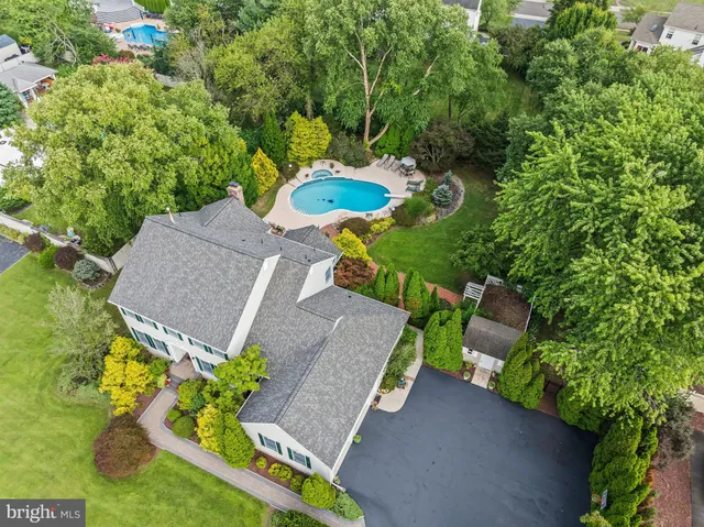 an aerial view of a house with a yard basket ball court and outdoor seating