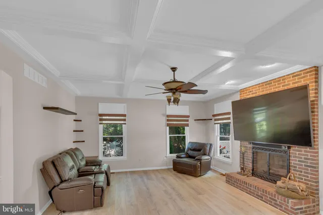 a living room with furniture and a ceiling fan