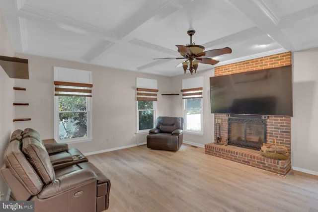 a kitchen with stainless steel appliances granite countertop a refrigerator a sink a stove and white cabinets