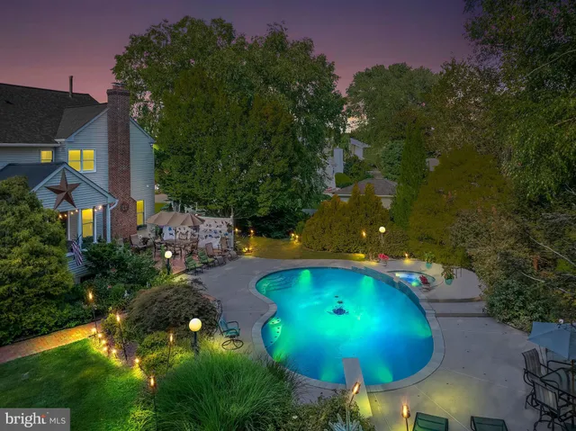 an aerial view of a house with swimming pool patio and outdoor seating