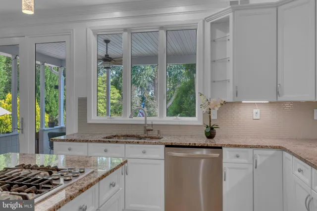 a bathroom with a granite countertop sink a toilet and shower