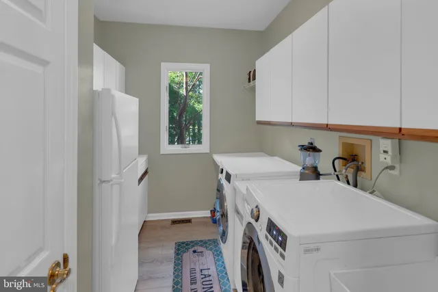 a bedroom with a bed dresser and a large window