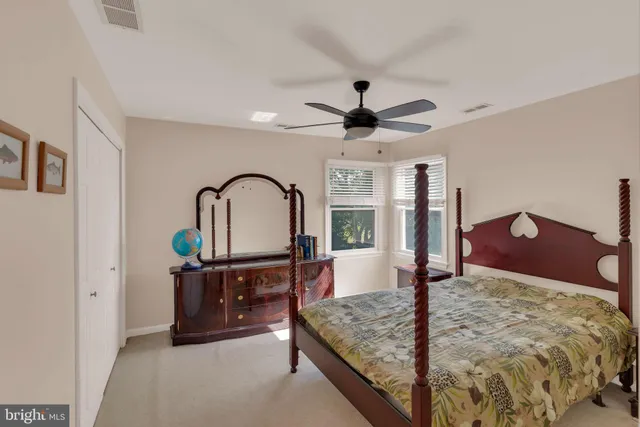 a view of a backyard with table and chairs and wooden fence
