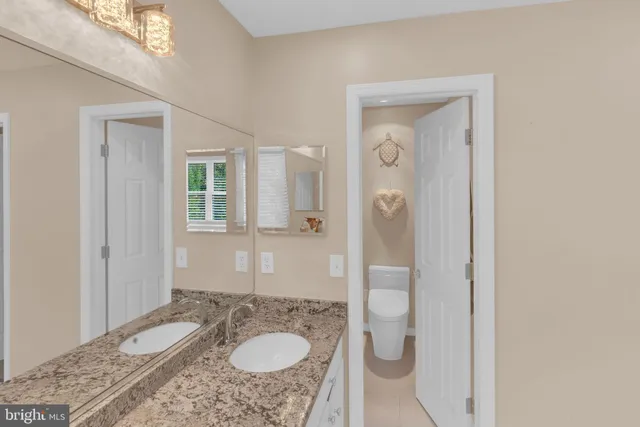 a view of a patio with furniture and table under an umbrella