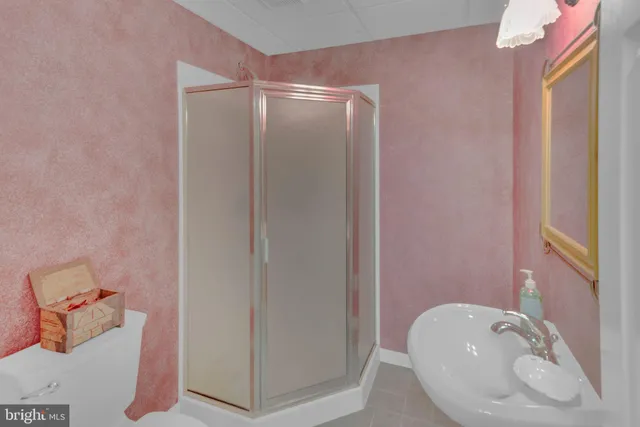 an aerial view of a house with a yard and lake view