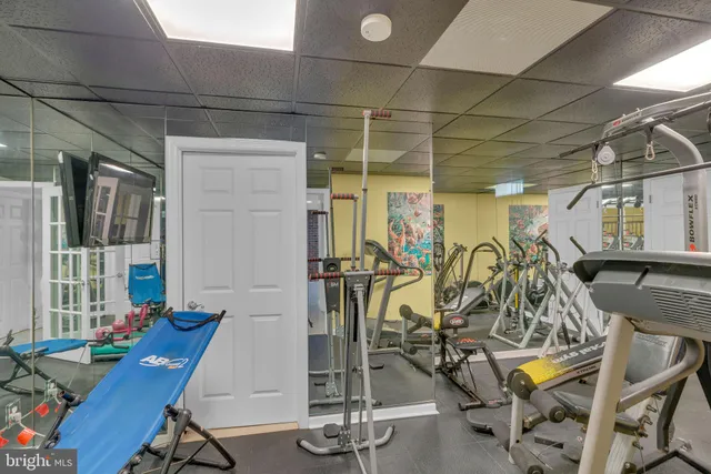 an aerial view of a house with swimming pool and trees
