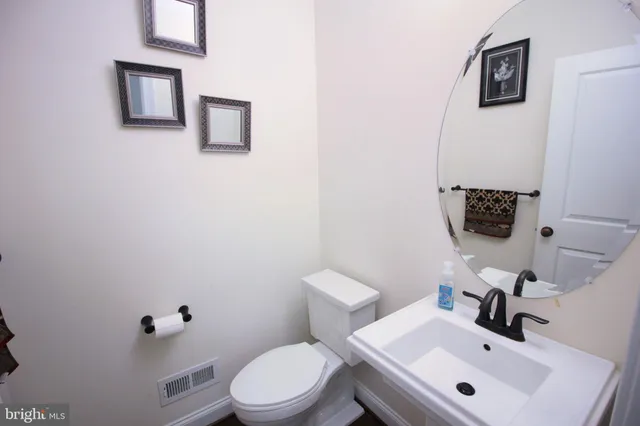 a bathroom with a sink mirror and toilet