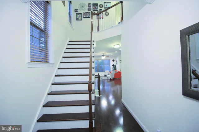 a view of entryway and hall with wooden floor