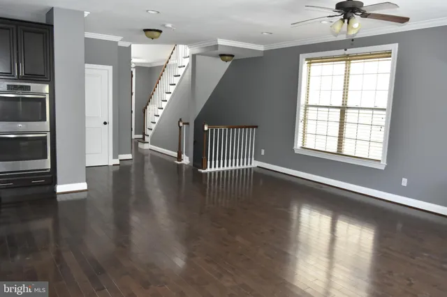 a view of room with a window and wooden floor