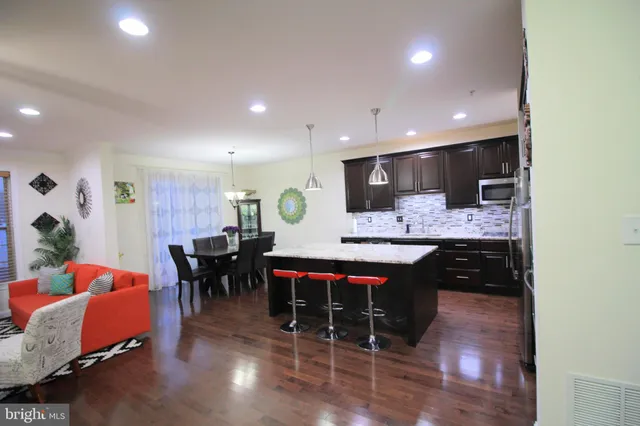 a large kitchen with a table and chairs