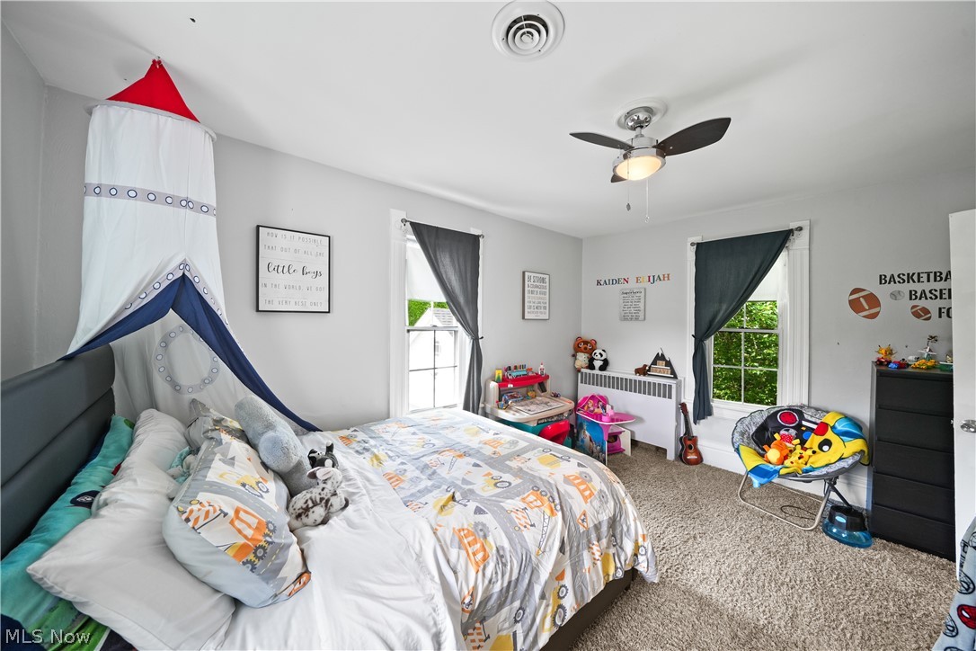 2069 State Road Northwest Warren, OH 44481 - Photo 24 of 45 Bedroom featuring ceiling fan, carpet floors, and radiator