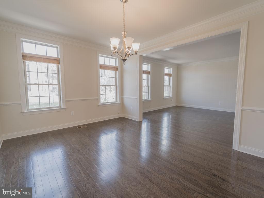 22595 Windsor Locks Square Ashburn, VA 20148 - Photo 15 of 56 a view of an empty room with wooden floor and a window