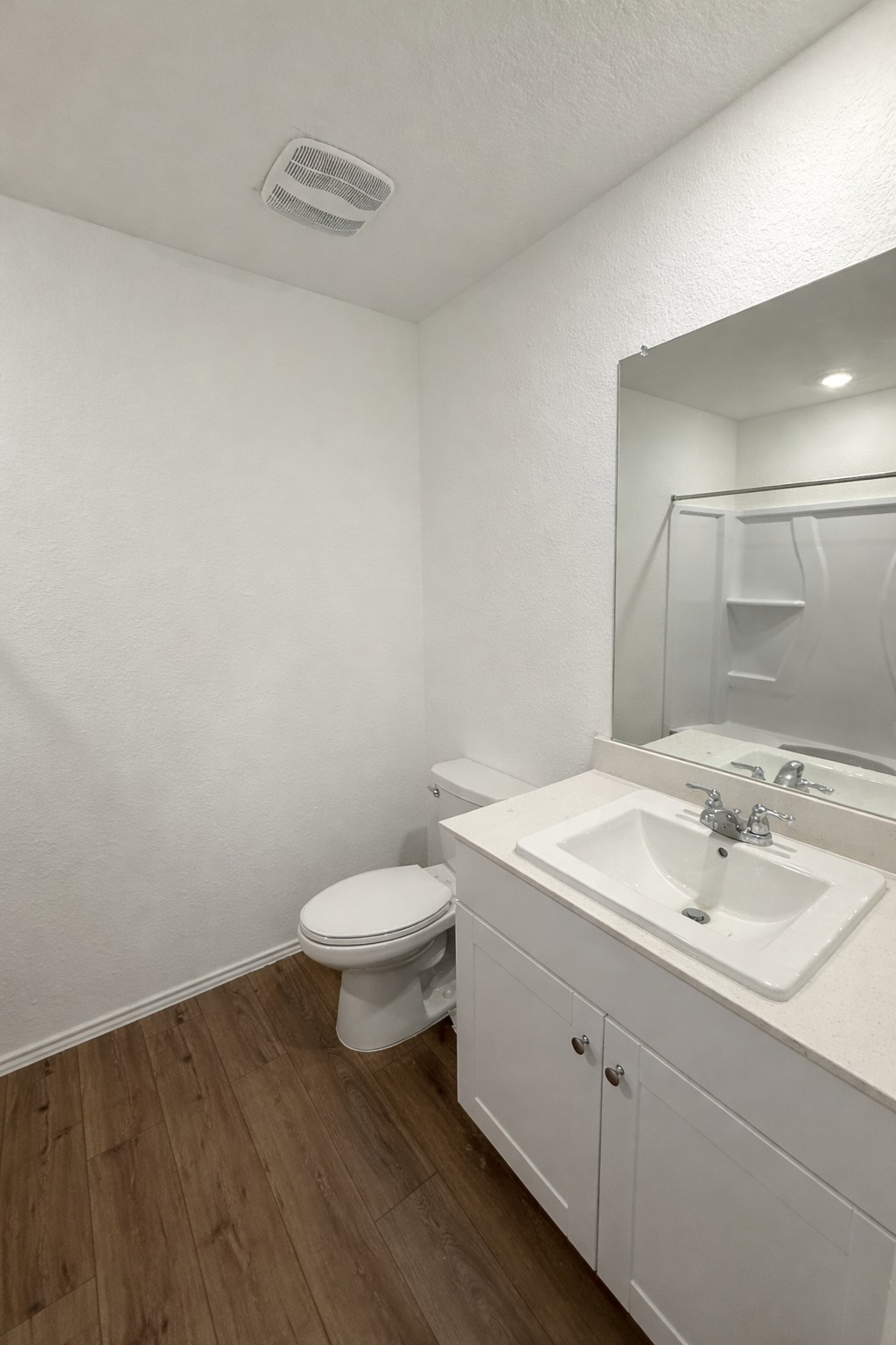 23408 Tiny Moons Way Elgin, TX 78621 - Photo 8 of 11 a bathroom with a toilet a sink and mirror