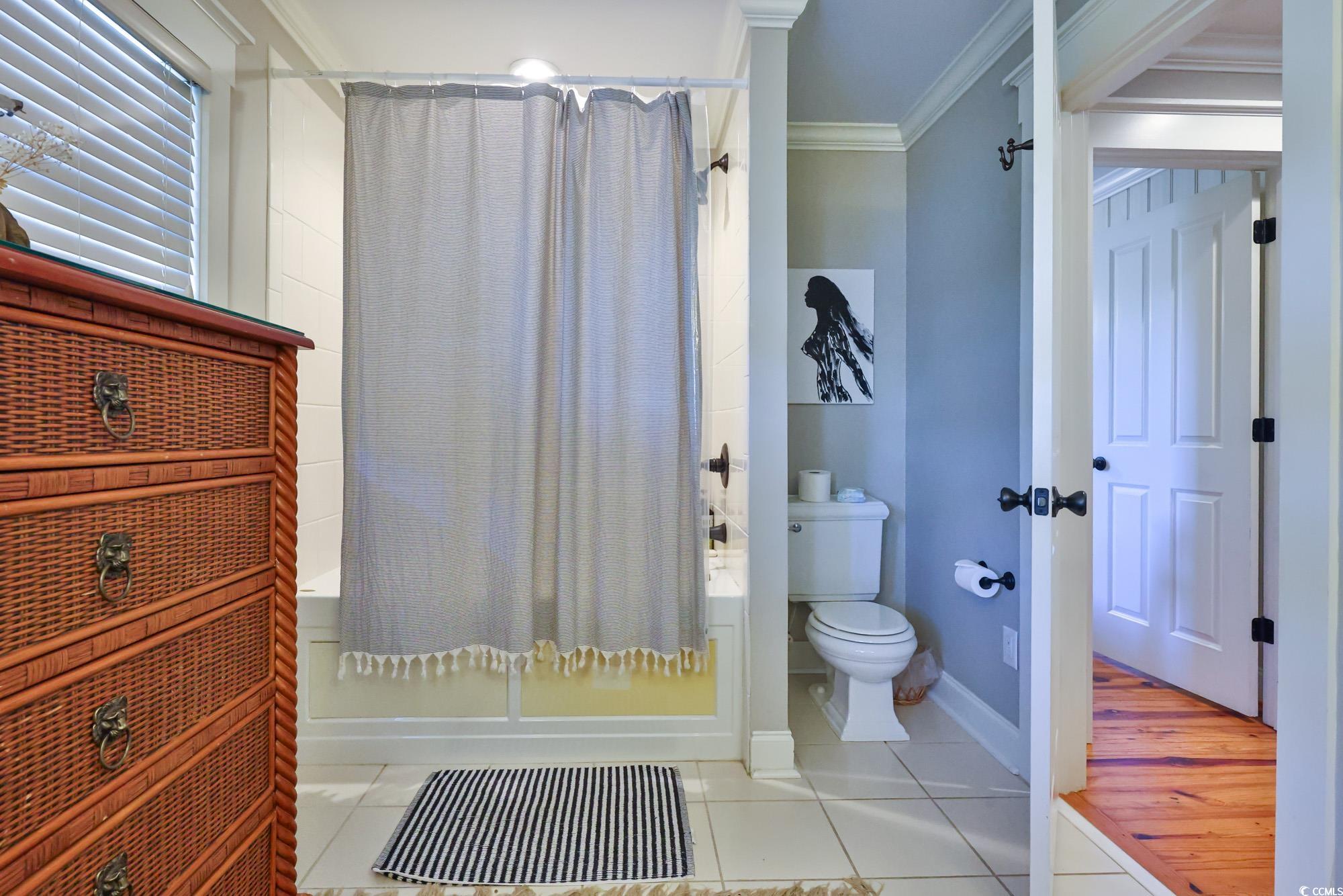 998 Shipmaster Avenue Myrtle Beach, SC 29579 - Photo 25 of 40 Bathroom featuring shower / tub combo, crown molding, and tile patterned flooring