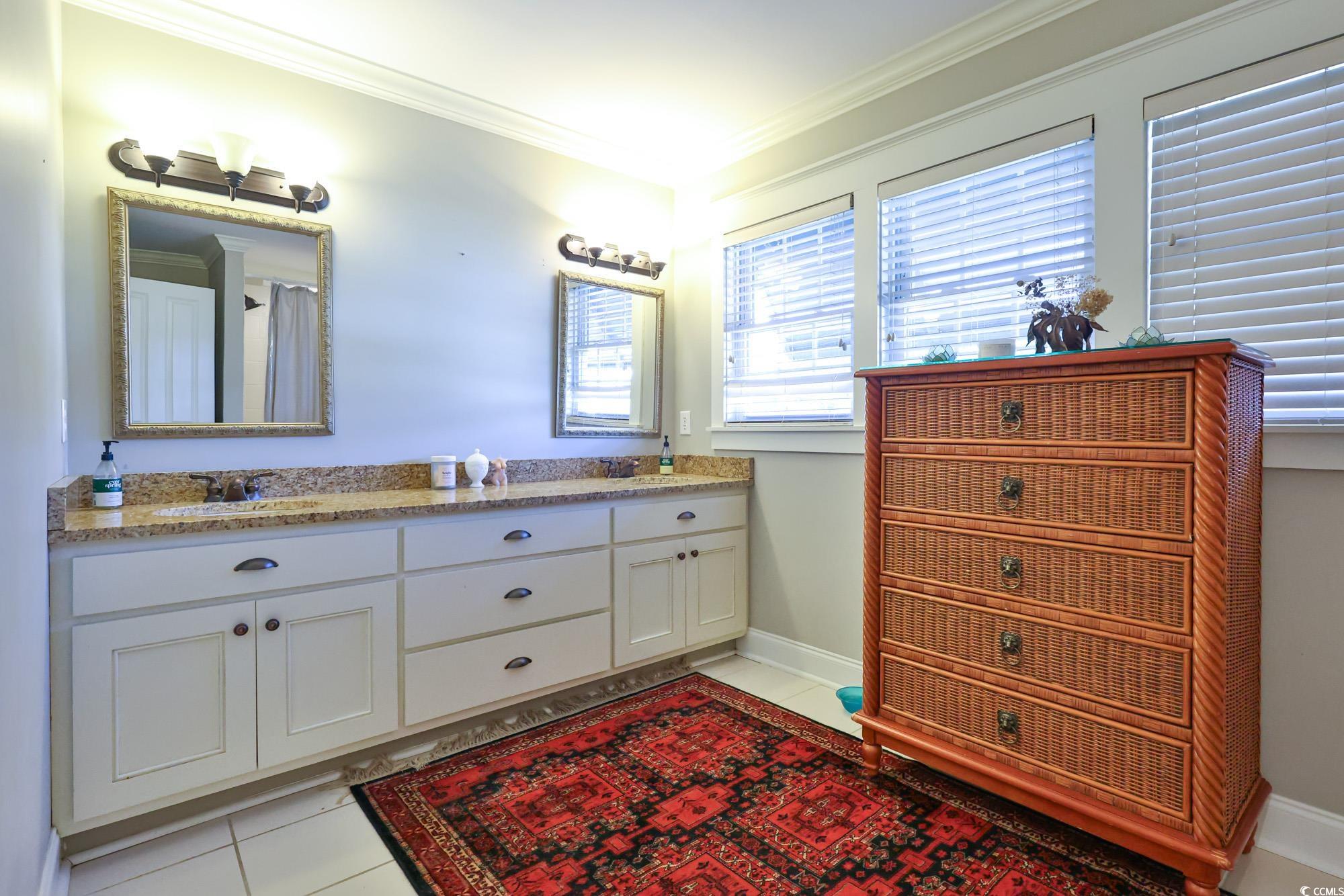 998 Shipmaster Avenue Myrtle Beach, SC 29579 - Photo 26 of 40 Full bath with ornamental molding, double vanity, light tile patterned floors, and a shower with shower curtain