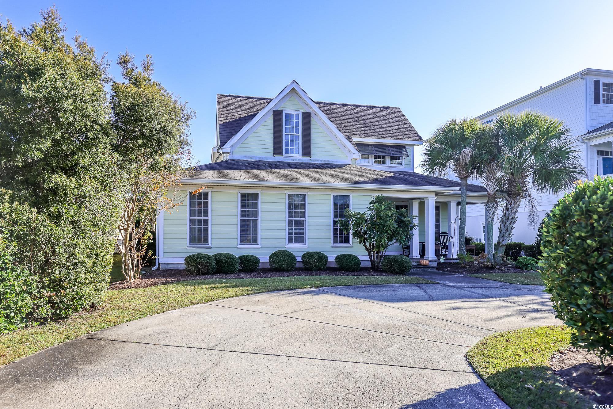 998 Shipmaster Avenue Myrtle Beach, SC 29579 - Photo 3 of 40 View of front of home featuring roof with shingles, a porch, and a front lawn