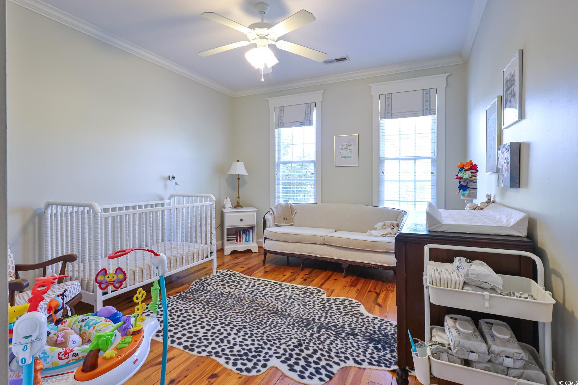 998 Shipmaster Avenue Myrtle Beach, SC 29579 - Photo 31 of 40 Bedroom with ornamental molding, wood finished floors, and ceiling fan