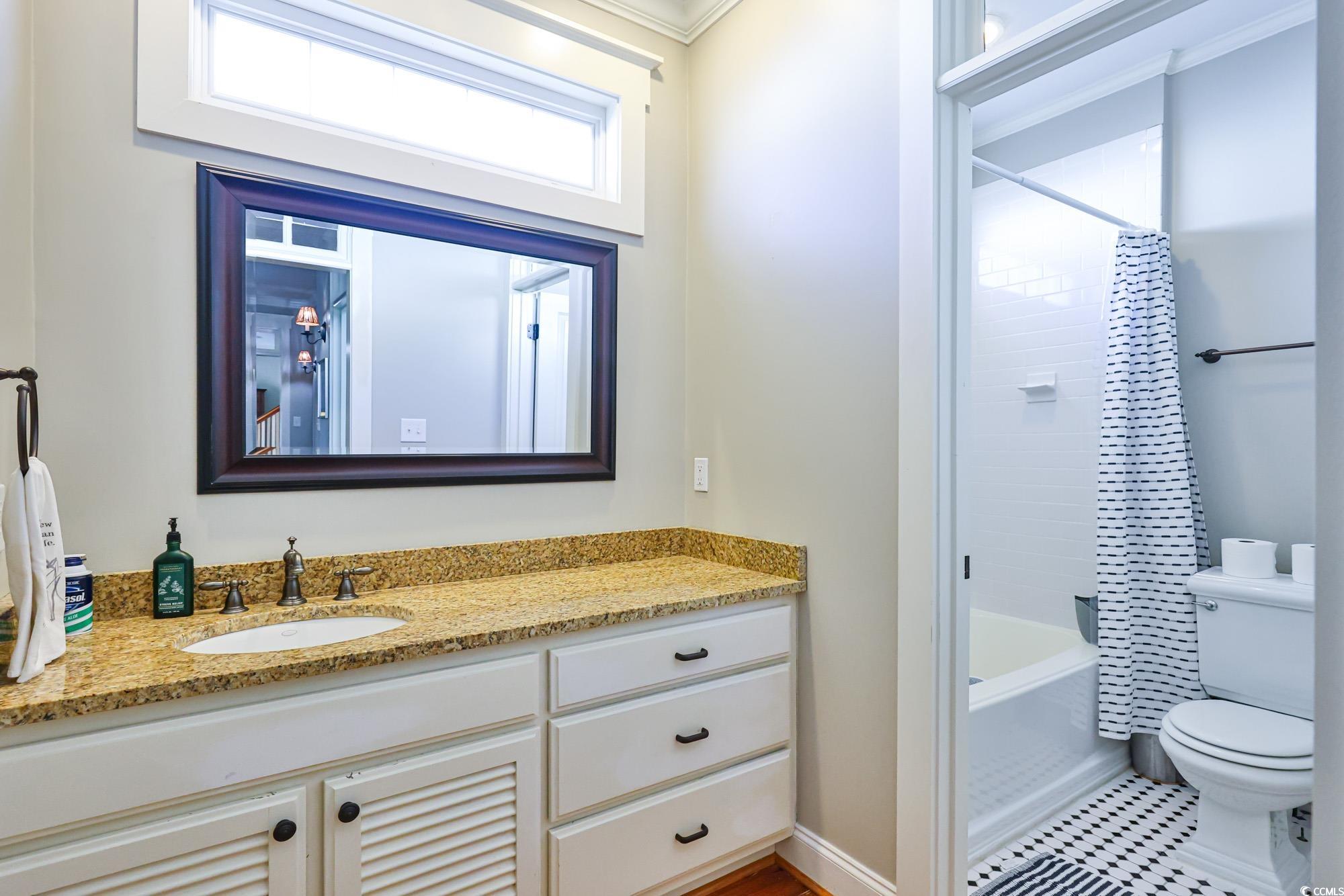 998 Shipmaster Avenue Myrtle Beach, SC 29579 - Photo 32 of 40 Full bathroom featuring shower / bathtub combination with curtain, vanity, and ornamental molding
