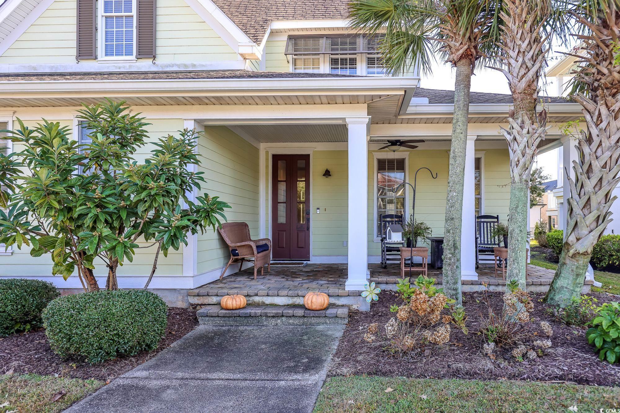 998 Shipmaster Avenue Myrtle Beach, SC 29579 - Photo 4 of 40 Entrance to property featuring covered porch, ceiling fan, and a shingled roof