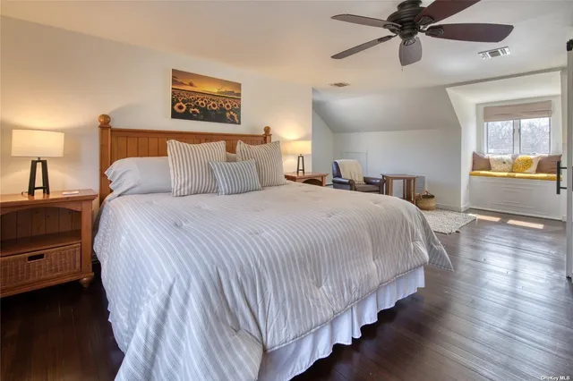 a bedroom with beds and a chandelier