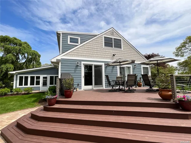 a front view of a house with a yard table and chairs