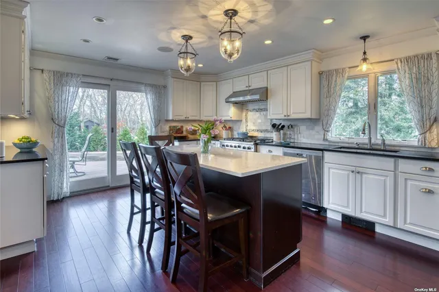 a kitchen with a table chairs stove and cabinets