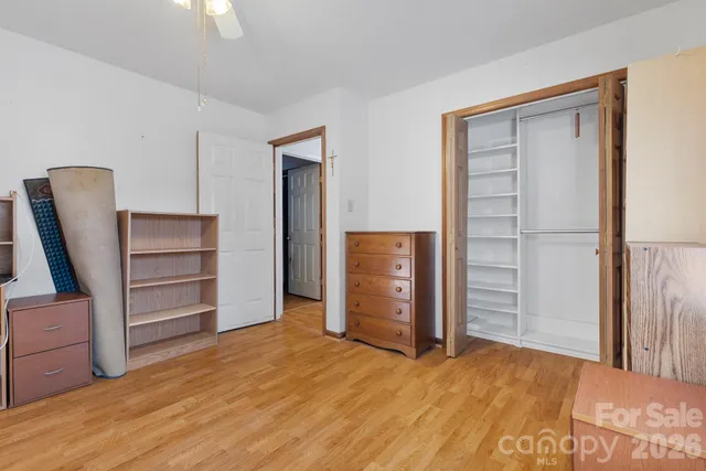 a view of a bedroom with closet and cabinet