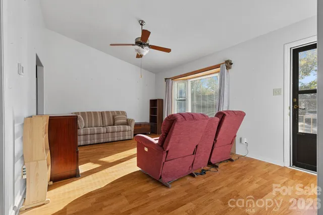 a living room with furniture rug and window