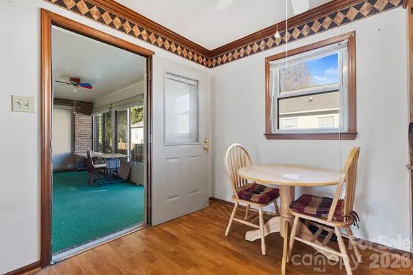 a view of a dining room with furniture and a window