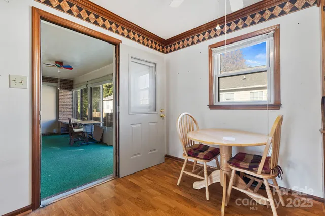 a view of a dining room with furniture and a window