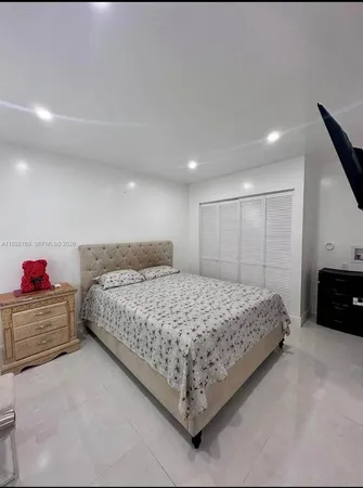 a bedroom with a bed and a dresser