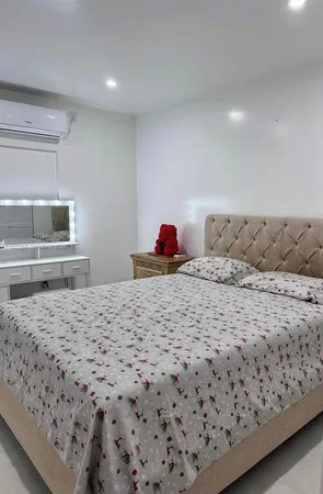 a bedroom with a bed and a flat screen television