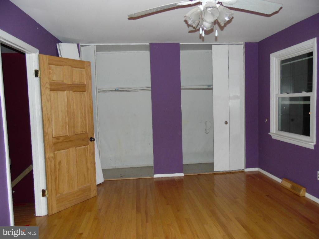 7921 Lynch Road Baltimore, MD 21222 - Photo 11 of 21 a view of empty room with wooden floor and cabinet