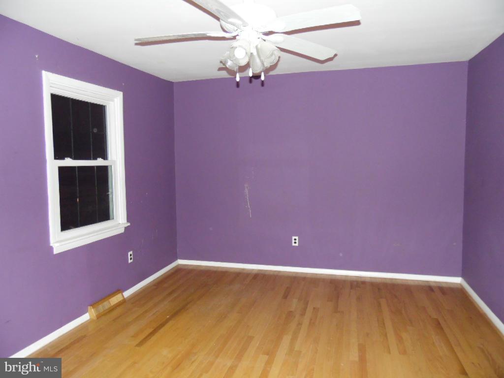 7921 Lynch Road Baltimore, MD 21222 - Photo 12 of 21 a view of a big room with wooden floor and chandelier fan
