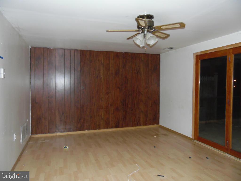 7921 Lynch Road Baltimore, MD 21222 - Photo 17 of 21 a view of empty room with ceiling fan