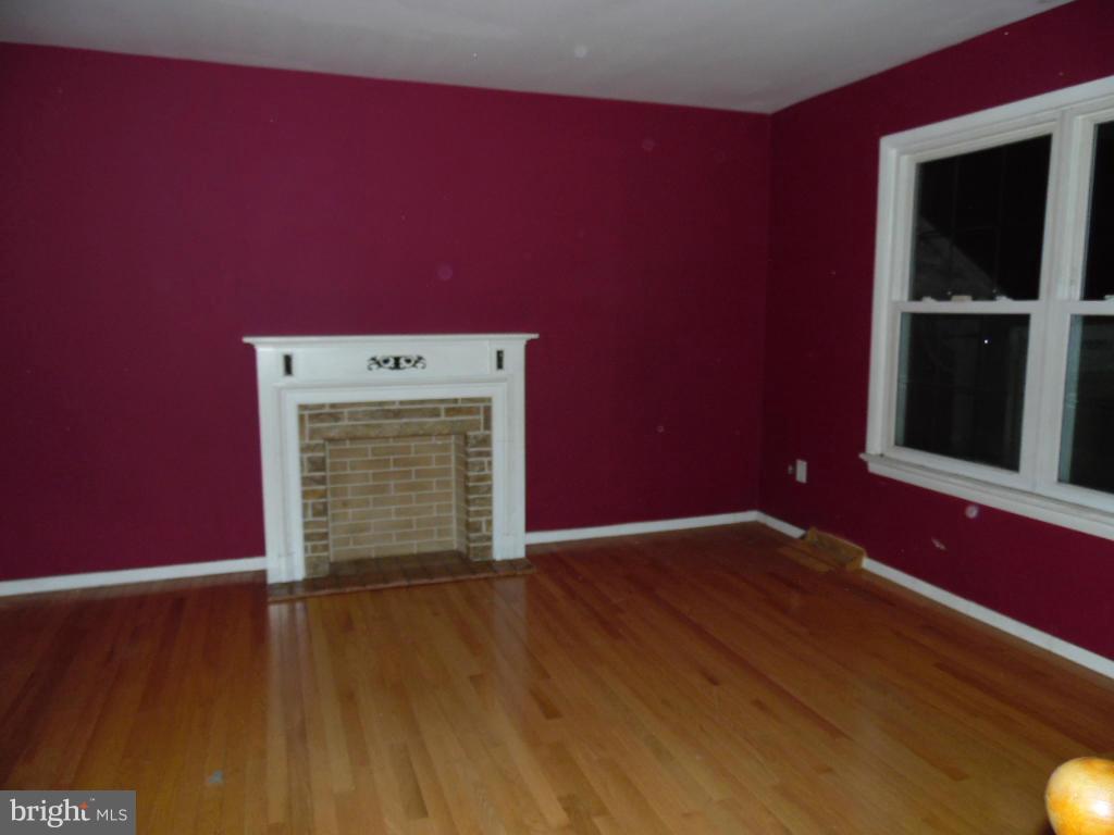 7921 Lynch Road Baltimore, MD 21222 - Photo 4 of 21 a view of empty room with wooden floor