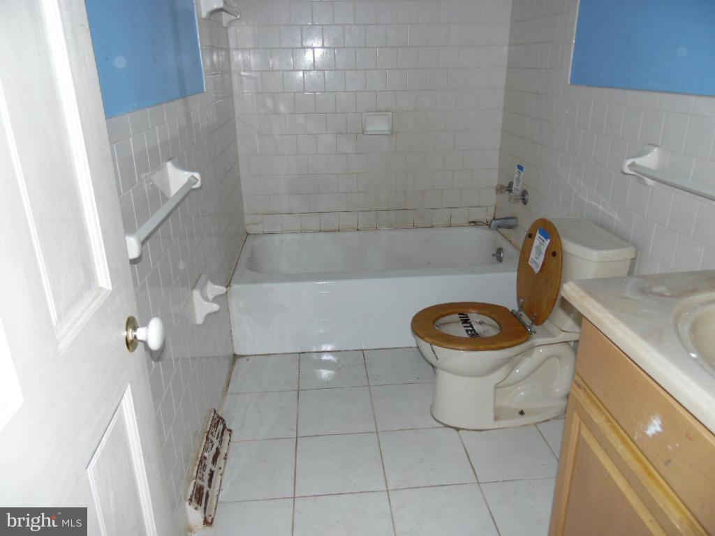 7921 Lynch Road Baltimore, MD 21222 - Photo 10 of 21 a bathroom with a toilet and a shower