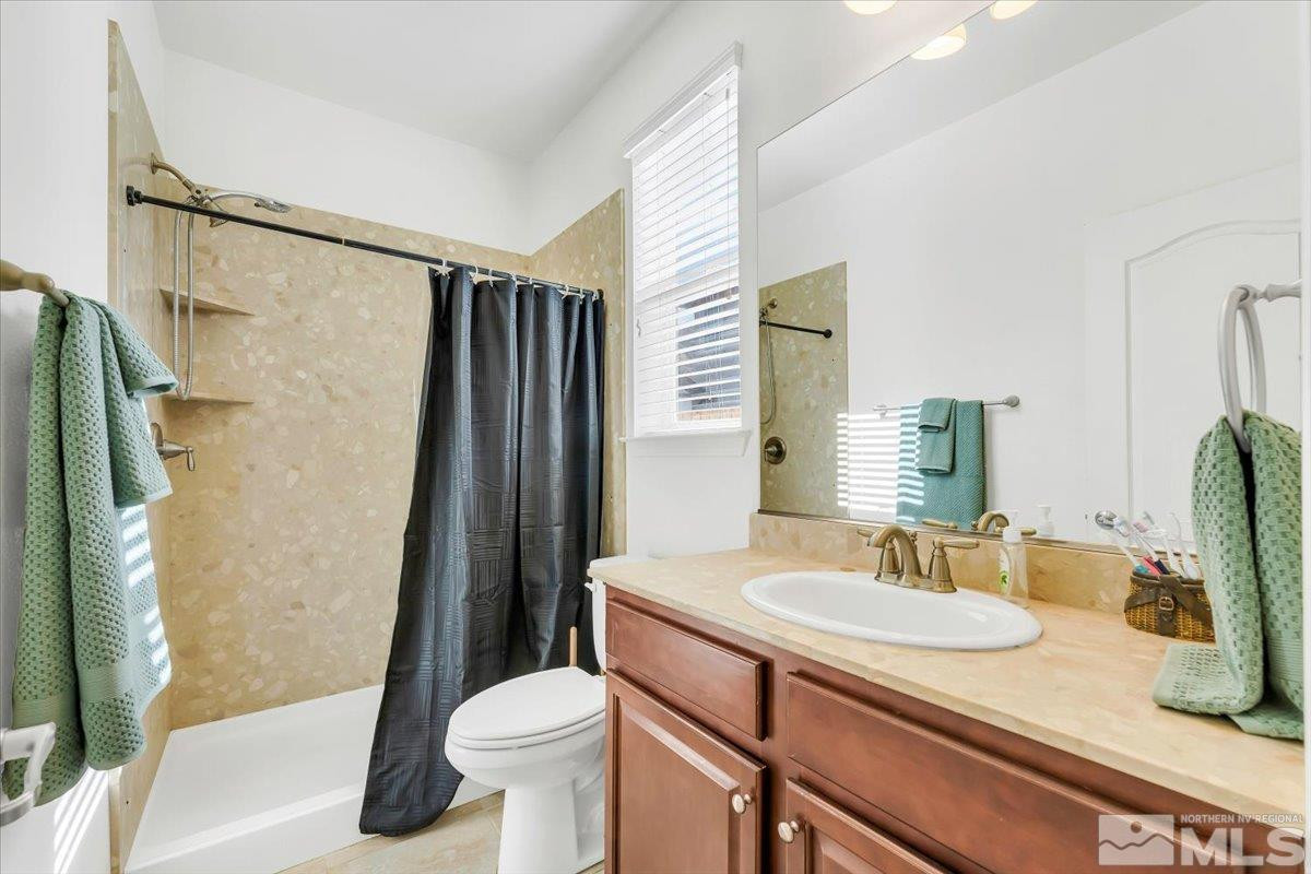 10050 Barrel Racer Drive Reno, NV 89521 - Photo 5 of 30 a bathroom with a sink toilet and shower