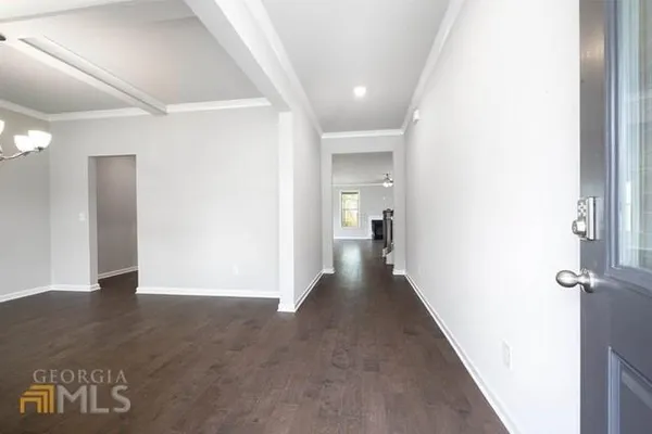 a view of a hallway with wooden floor