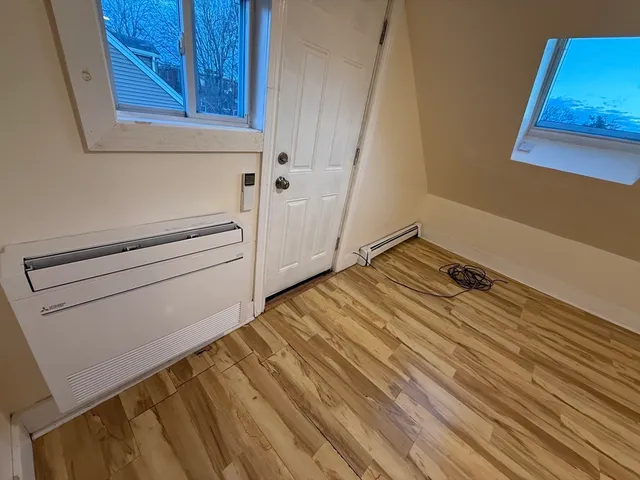 a view of a room with wooden floor and cabinet
