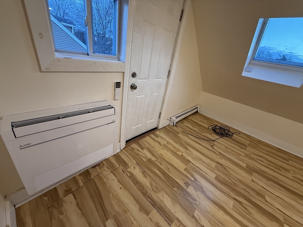 1208 Morton Street, Unit 3 Boston, MA 02126 - Photo 11 of 17 a view of a room with wooden floor and cabinet