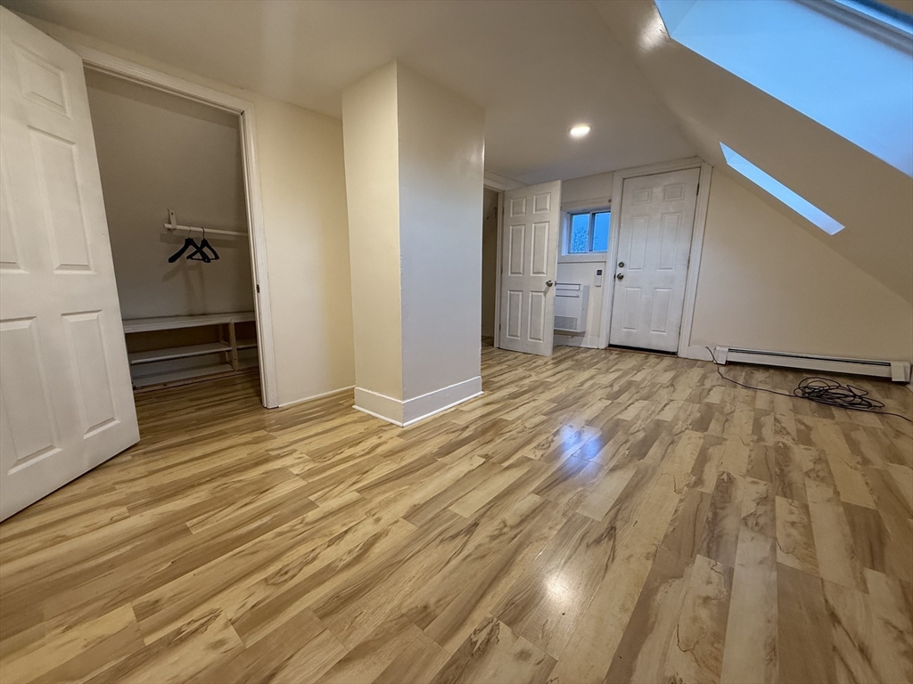 1208 Morton Street, Unit 3 Boston, MA 02126 - Photo 15 of 17 a view of a room with wooden floor and cabinet