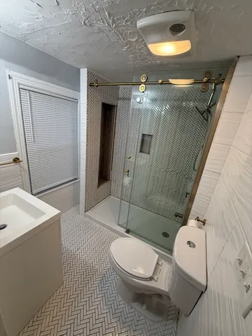a bathroom with a toilet a sink and shower