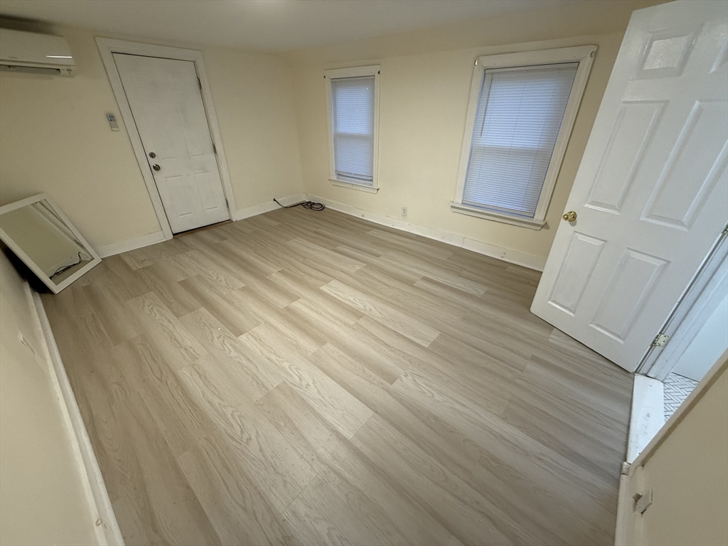 1208 Morton Street, Unit 3 Boston, MA 02126 - Photo 7 of 17 a view of an empty room with wooden floor