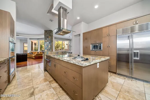 a kitchen with stainless steel appliances a sink stove and refrigerator