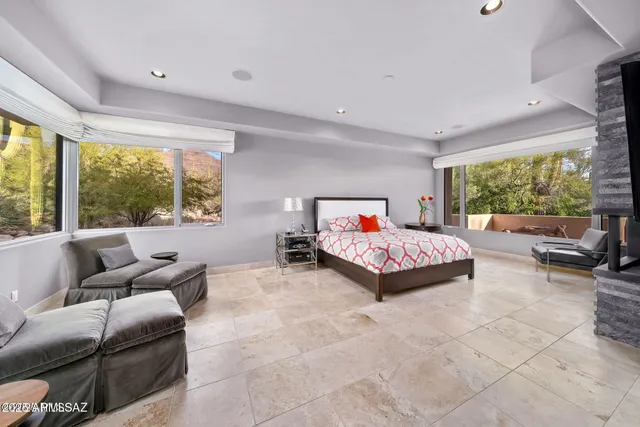 a bedroom with furniture and a large window